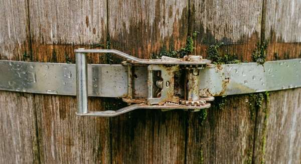 Close-up of stainless steel tension band around barrel sauna